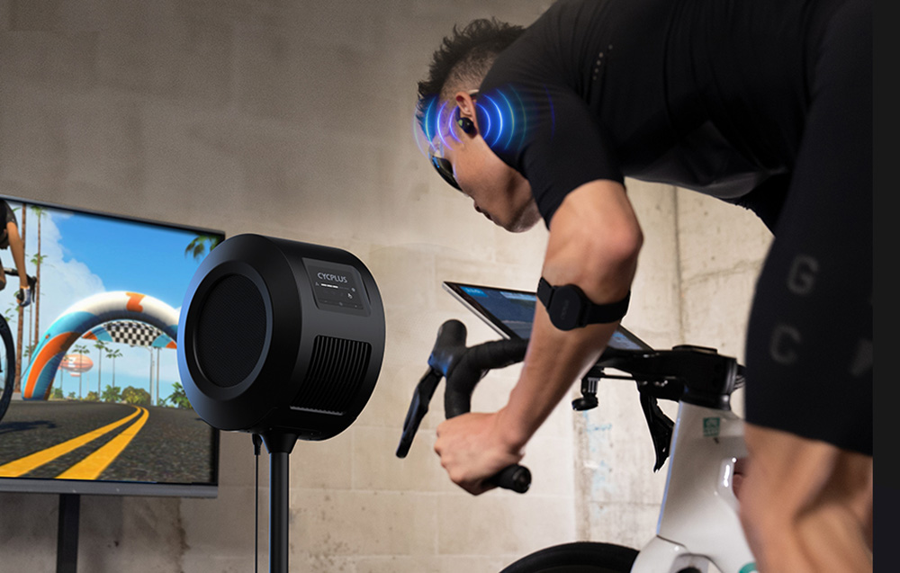 Personne s'entraînant sur un vélo avec ventilateur et graphiques de bip