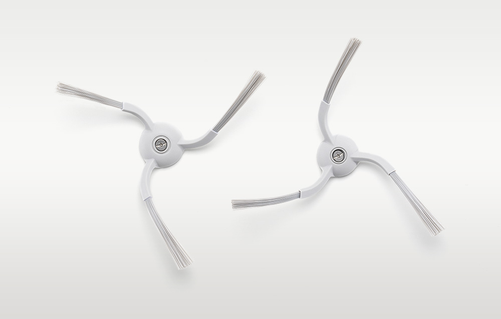 Deux brosses latérales pour le robot de nettoyage disposées sur un fond clair