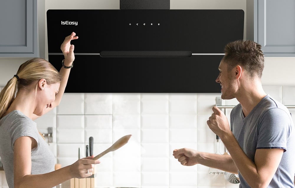 Un homme et une femme parlent sous la hotte noire dans une cuisine lumineuse